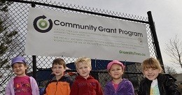 Kids in front of OTS community grant signage